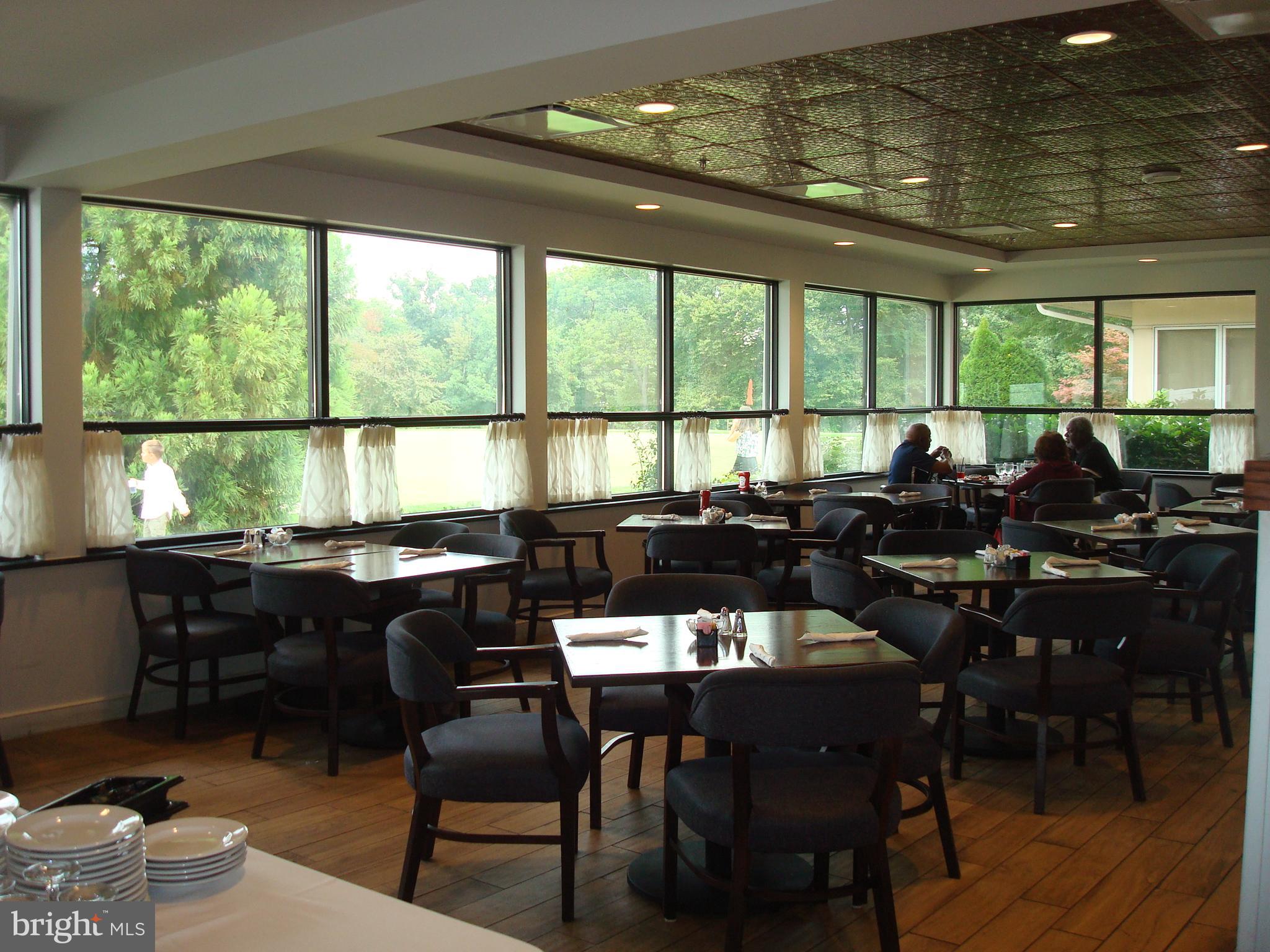 3210 North Leisure World Boulevard, Unit 1001 Silver Spring, MD 20906 - Photo 42 of 58 a view of a dining room with furniture window and outside view