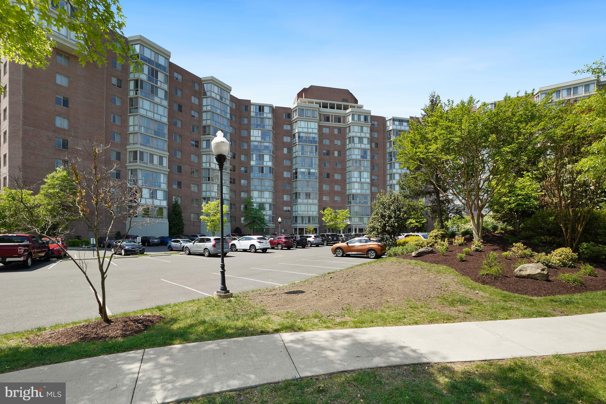 3210 North Leisure World Boulevard, Unit 1001 Silver Spring, MD 20906 - Photo 58 of 58 a row of tall buildings with trees in front of it