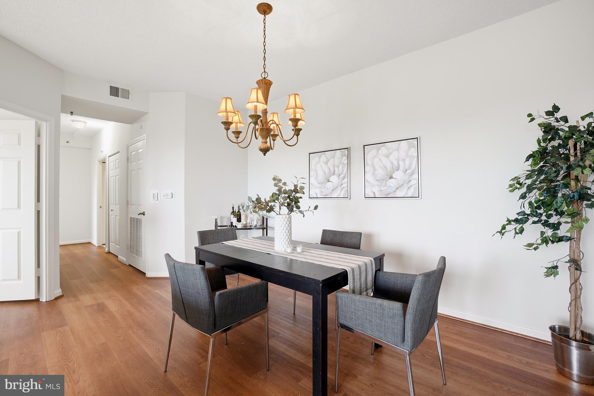 3210 North Leisure World Boulevard, Unit 1001 Silver Spring, MD 20906 - Photo 7 of 58 a view of a dining room with furniture and wooden floor