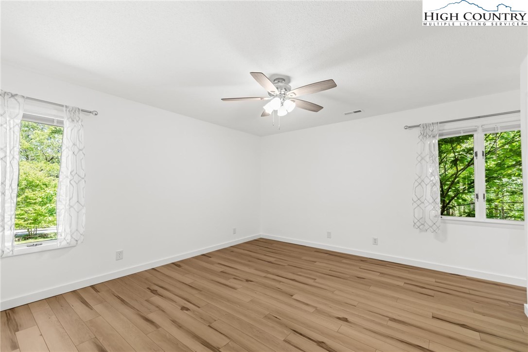 219 Hillandale Drive Boone, NC 28607 - Photo 11 of 33 an empty room with wooden floor and window