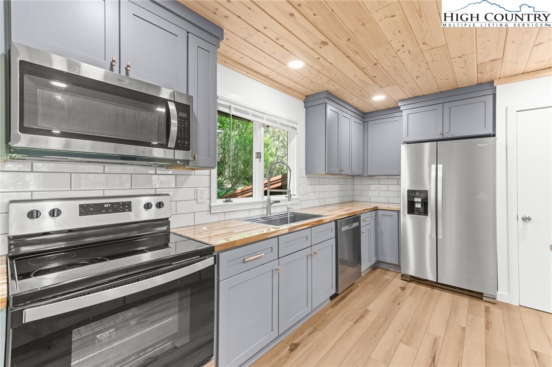 219 Hillandale Drive Boone, NC 28607 - Photo 7 of 33 a kitchen with stainless steel appliances a stove microwave and sink