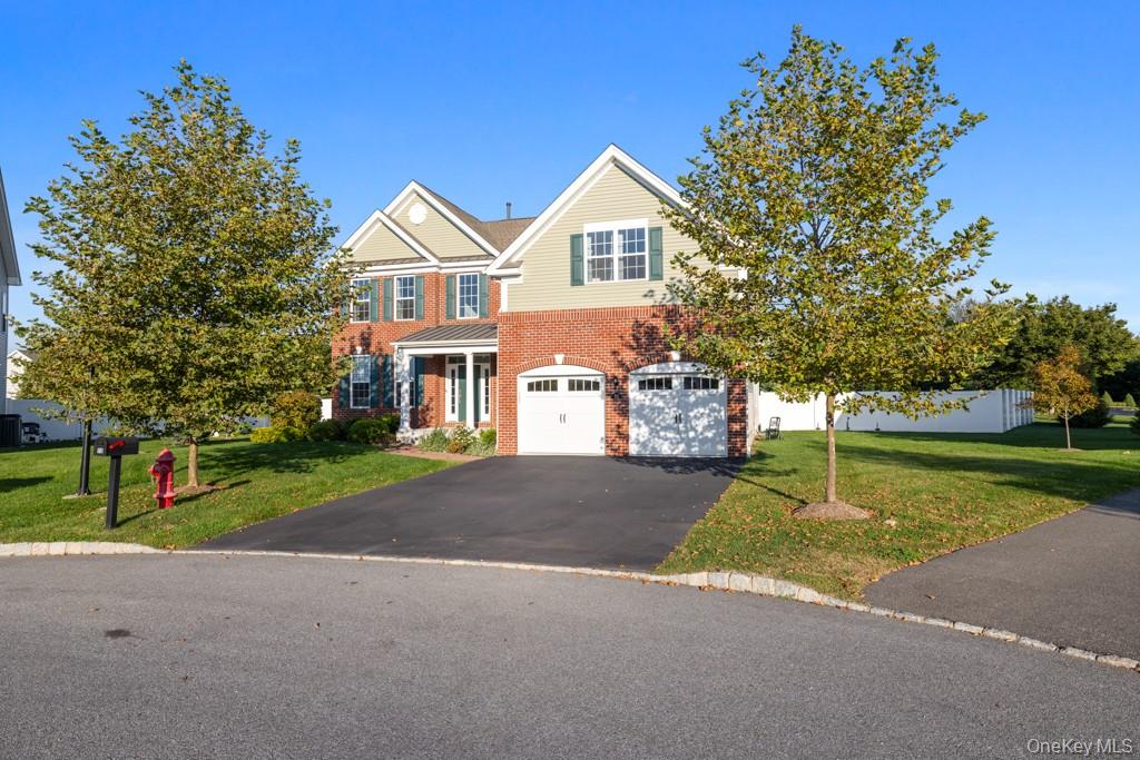 58 Pitcher Road Hopewell Junction, NY 12533 - Photo 1 of 1 View of front of house featuring a front lawn, brick siding, asphalt driveway, and an attached garage