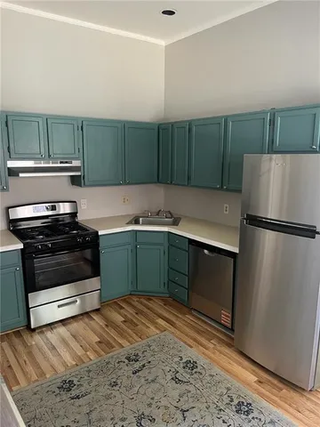 a kitchen with a refrigerator and a sink