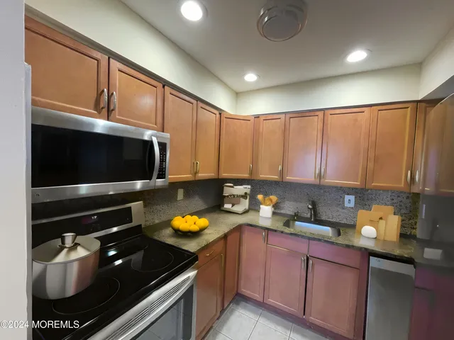 a kitchen with a sink a stove and cabinets