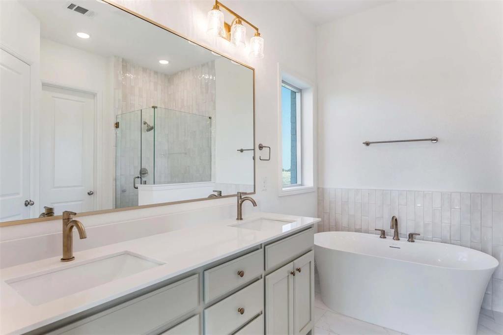 179 Galena Street Rhome, TX 76078 - Photo 10 of 17 a bathroom with a sink and a mirror