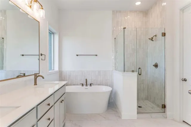 a bathroom with a bathtub shower sink and mirror