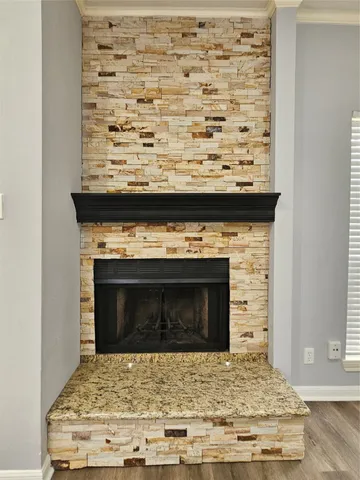 a bathroom with a granite countertop toilet sink a mirror and a window