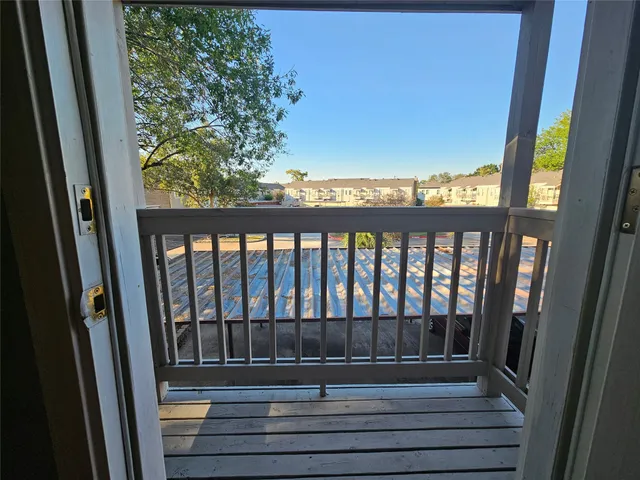 a view of a patio with table and chairs with wooden floor and fence