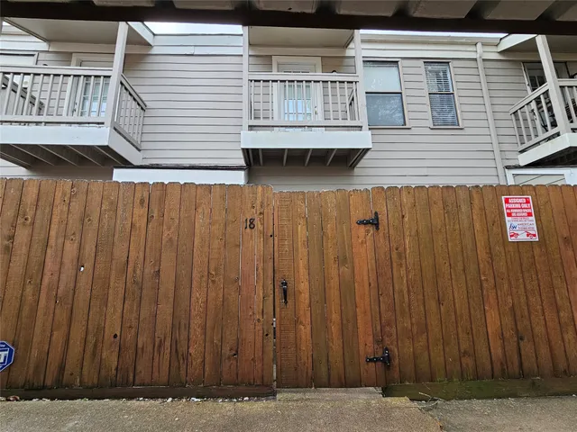 a view of wooden house with wooden fence