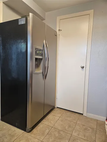 an empty room with windows fireplace and wooden floor