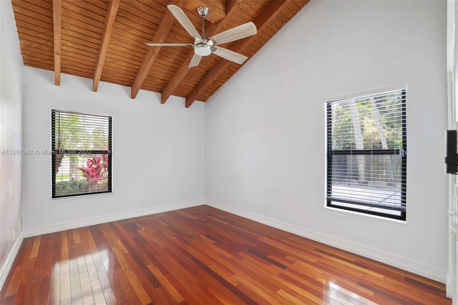 1501 Northwest 12th Terrace Boca Raton, FL 33486 - Photo 17 of 49 a view of a room with wooden floor and windows