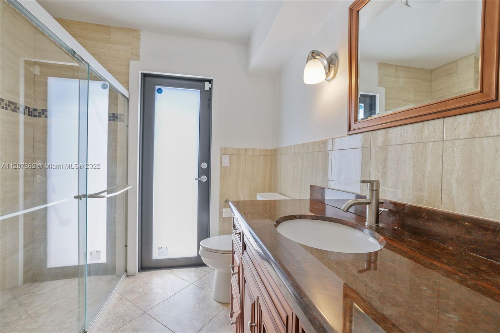 1501 Northwest 12th Terrace Boca Raton, FL 33486 - Photo 19 of 49 a bathroom with a sink and a mirror