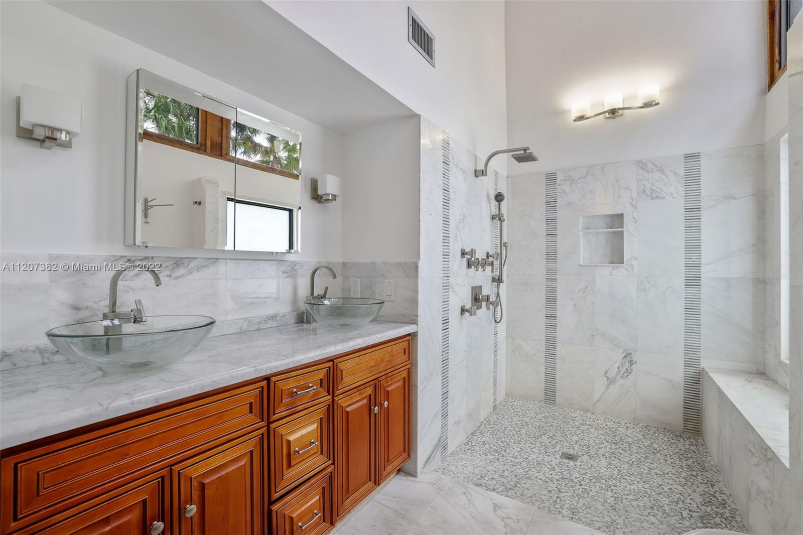 1501 Northwest 12th Terrace Boca Raton, FL 33486 - Photo 23 of 49 a bathroom with a granite countertop sink mirror and shower
