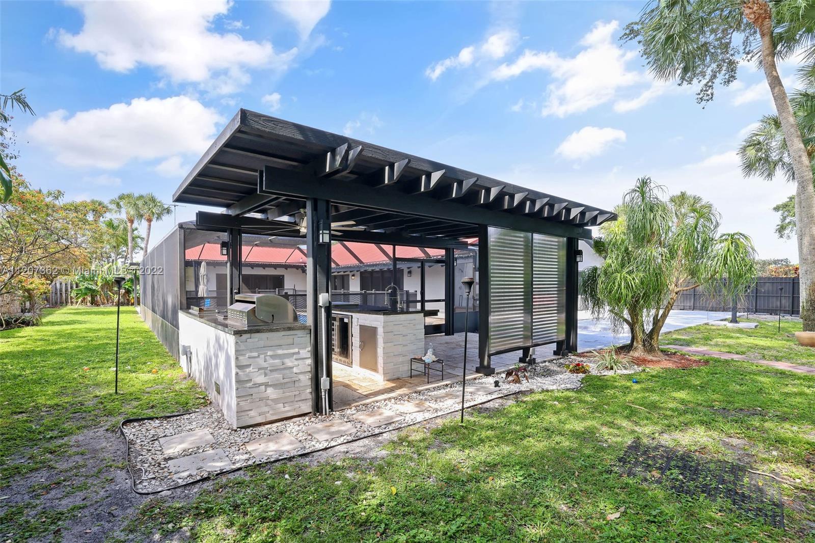 1501 Northwest 12th Terrace Boca Raton, FL 33486 - Photo 39 of 49 a view of a backyard with sitting area and slide
