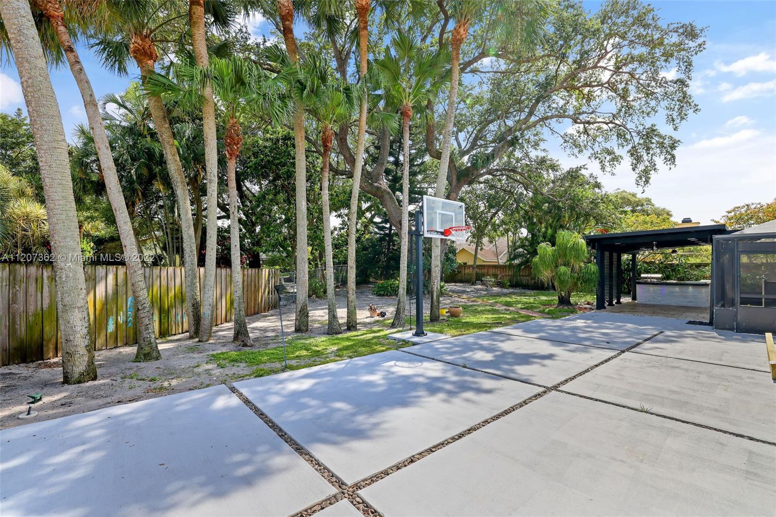 1501 Northwest 12th Terrace Boca Raton, FL 33486 - Photo 41 of 49 a view of a park with potted plants and a large tree