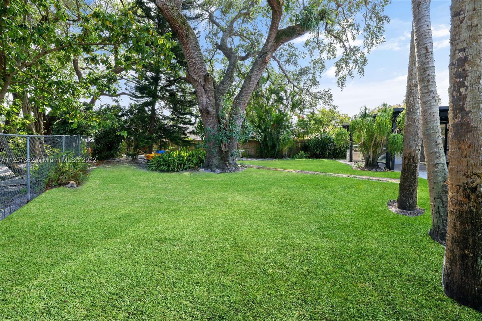 1501 Northwest 12th Terrace Boca Raton, FL 33486 - Photo 49 of 49 a view of a grassy field with trees in the back