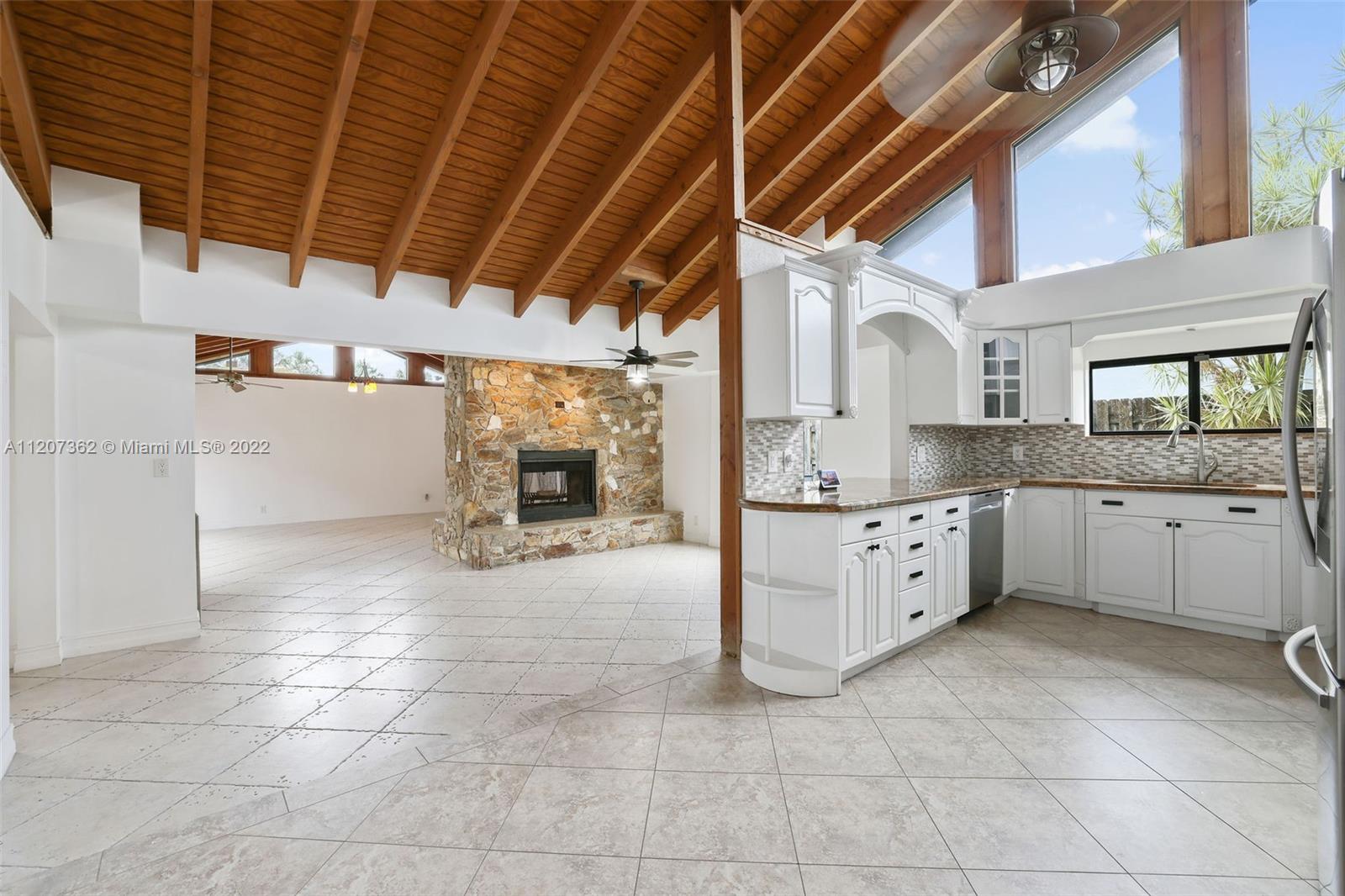 1501 Northwest 12th Terrace Boca Raton, FL 33486 - Photo 6 of 49 a kitchen with stainless steel appliances granite countertop a sink and cabinets