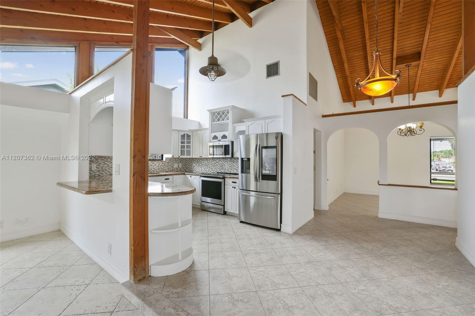 1501 Northwest 12th Terrace Boca Raton, FL 33486 - Photo 8 of 49 a view of a kitchen with microwave and stove top oven