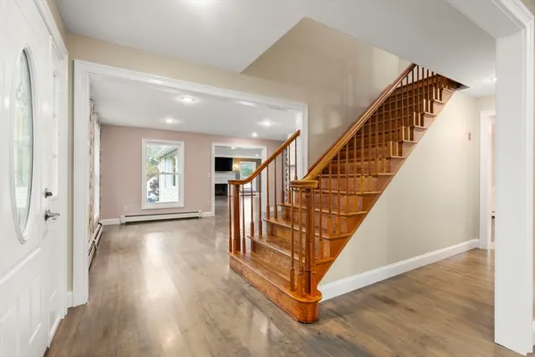 a view of entryway with wooden floor and stairs