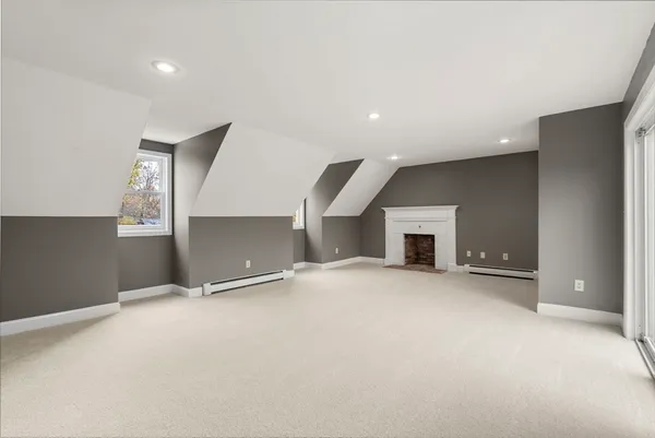 an empty room with a fireplace and cabinet