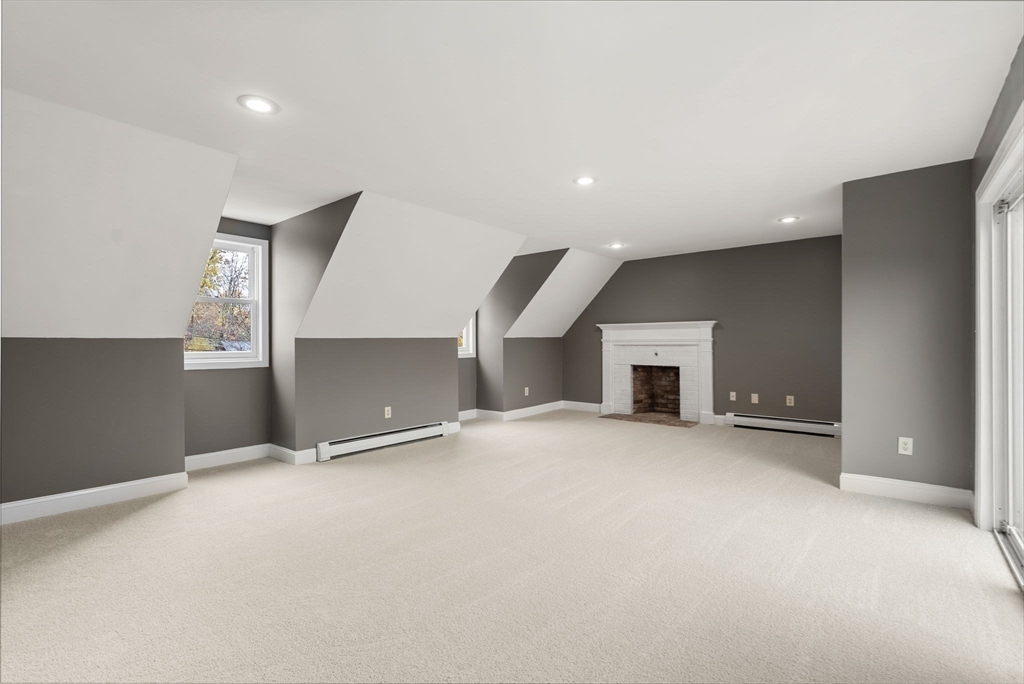 163 South Shelburne Road Greenfield, MA 01301 - Photo 16 of 36 an empty room with a fireplace and cabinet