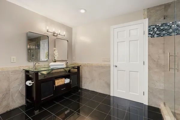 a bathroom with a sink a toilet and mirror