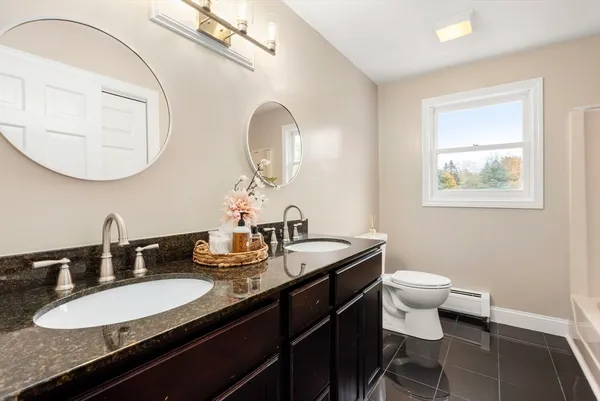 a bathroom with a double vanity sink and a mirror