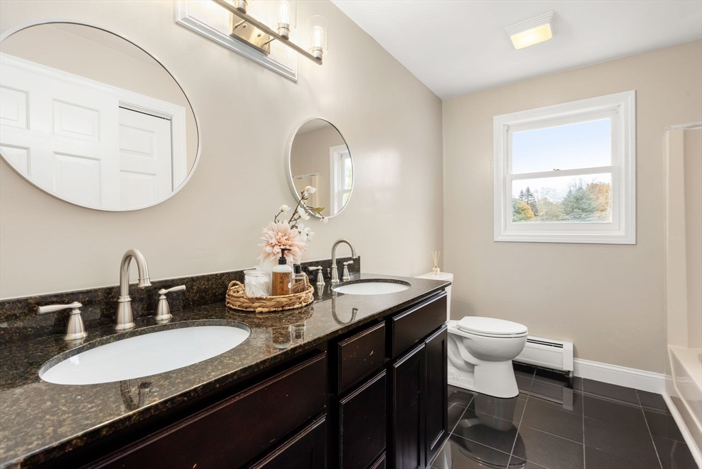 163 South Shelburne Road Greenfield, MA 01301 - Photo 24 of 36 a bathroom with a double vanity sink and a mirror
