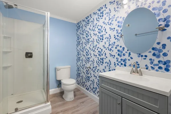 a bathroom with a sink toilet and shower