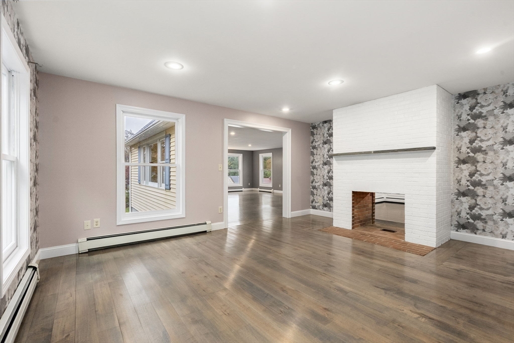 163 South Shelburne Road Greenfield, MA 01301 - Photo 3 of 36 an empty room with wooden floor and fireplace