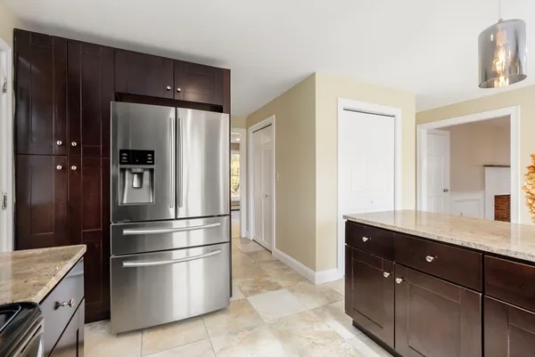 a kitchen with stainless steel appliances granite countertop a refrigerator and a sink