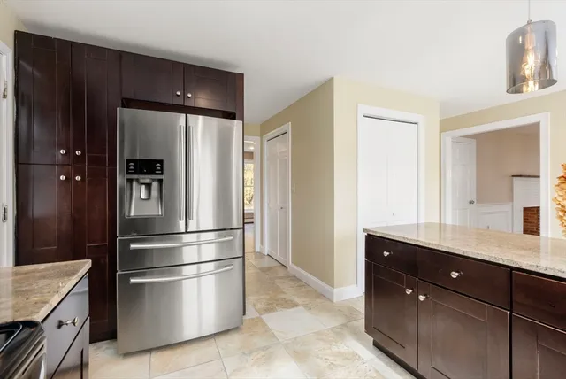 a kitchen with stainless steel appliances granite countertop a refrigerator and a sink