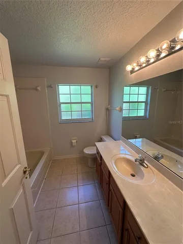 a bathroom with a sink a vanity and a mirror