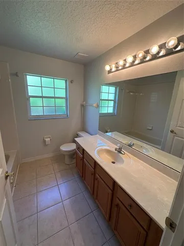 an empty room with a ceiling fan and window