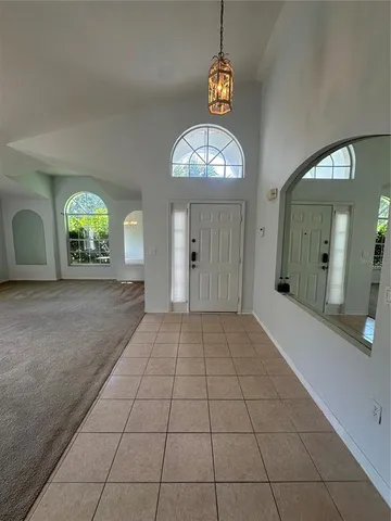 an empty room with fan and mirror