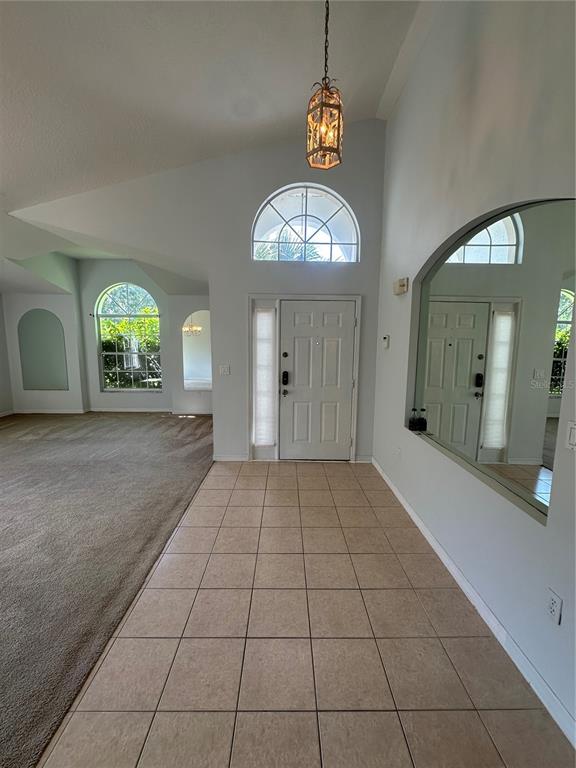 2823 Drifting Lilly Loop Kissimmee, FL 34747 - Photo 2 of 25 an empty room with fan and mirror