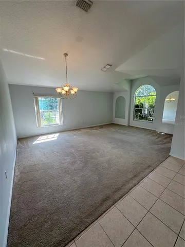 an empty room with windows and entrance