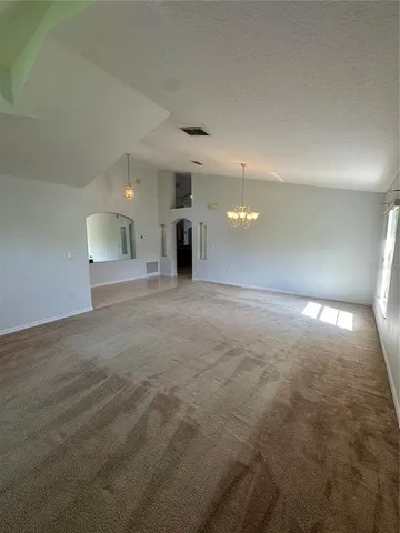 an empty room with windows and entrance