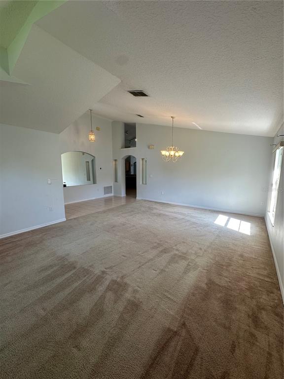 2823 Drifting Lilly Loop Kissimmee, FL 34747 - Photo 6 of 25 an empty room with windows and entrance