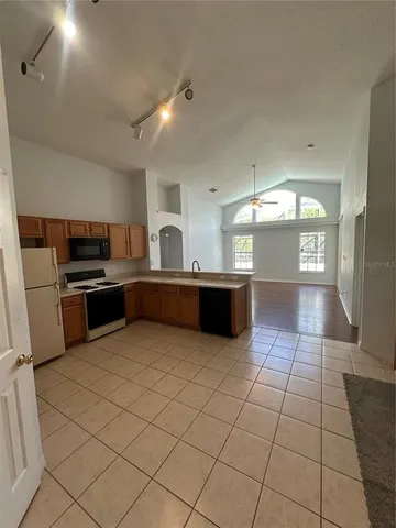 a large kitchen with cabinets and stainless steel appliances