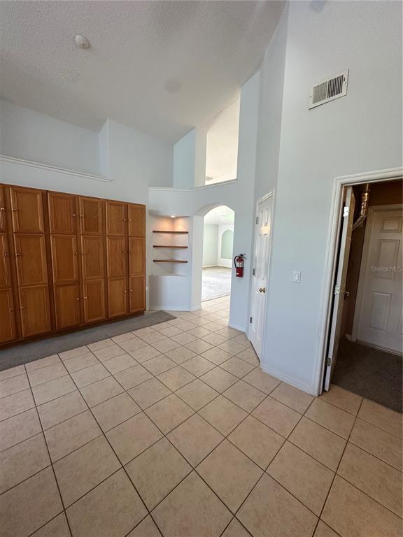 2823 Drifting Lilly Loop Kissimmee, FL 34747 - Photo 8 of 25 a room with a washing machine and cabinets
