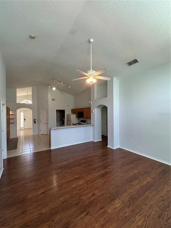 2823 Drifting Lilly Loop Kissimmee, FL 34747 - Photo 10 of 25 a view of an empty room with window and wooden floor