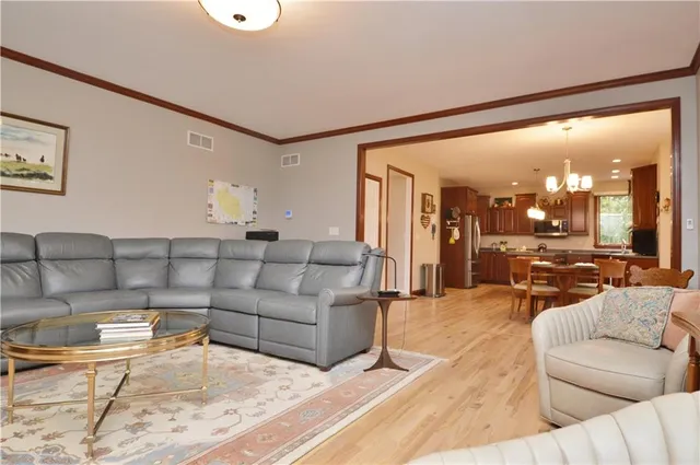 a living room with furniture and view of kitchen