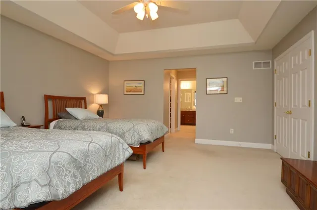 a bedroom with bed and a chandelier