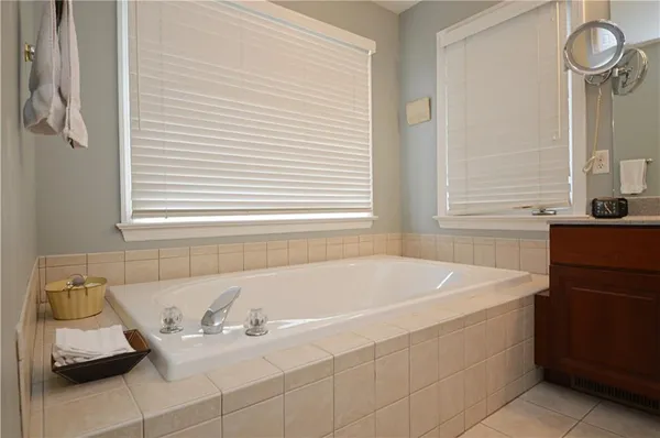 a bath tub sitting in a bathroom next to a window