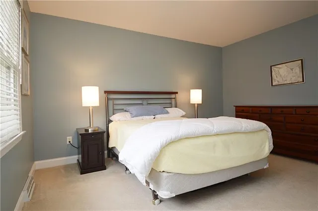 a bed sitting in a bedroom next to a window