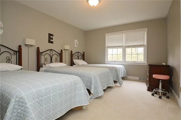 a bedroom with a bed a table and chair