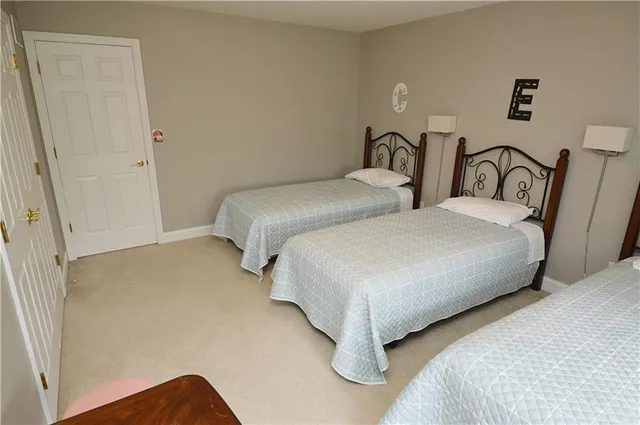 a bedroom with two beds and painted walls