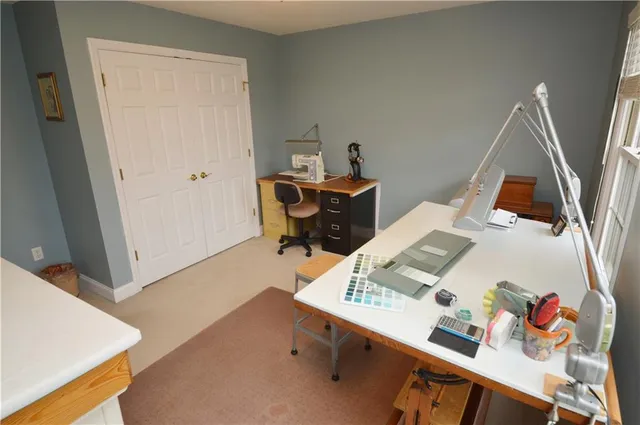 a view of a workspace with furniture and wooden floor