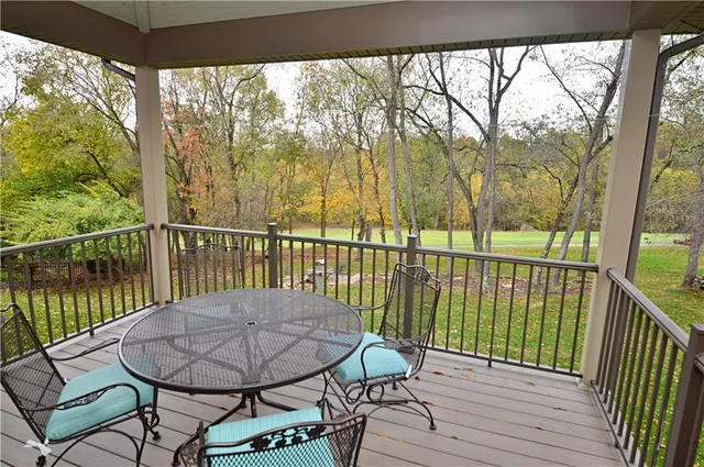 a view of a balcony with furniture and wooden floor